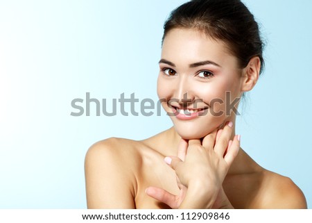 beautiful cheerful teen girl beauty face happy smiling and looking at camera over blue background