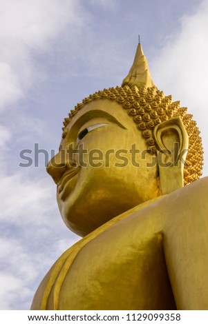 Buddha in Thailand marvelous with backdrop of the picture is a rain cloud. The most beautiful and biggest Buddha image.The Buddha statues or Buddha images. 
