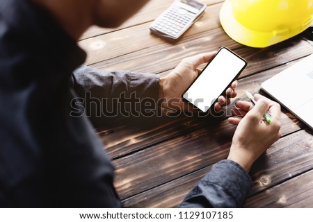 engineering using phone mobile on desk