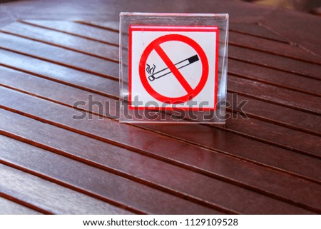Non smoking sign on wooden table
