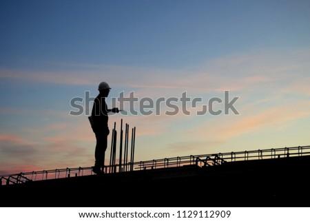 Construction worker using CB radio on a construction site,for construction teams to work in heavy industry