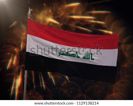 Flag of Iraq with fireworks display in the background