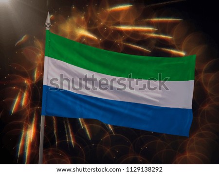 Flag of Sierra Leone with fireworks display in the background