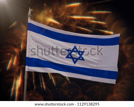 Flag of Israel with fireworks display in the background