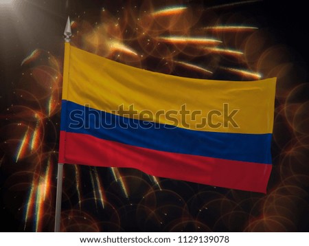 Flag of Colombia with fireworks display in the background
