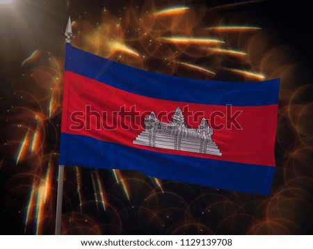 Flag of Cambodia with fireworks display in the background