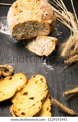 Fresh and delicious whole wheat bread, bagels or loaf on wooden table for healthy diet background