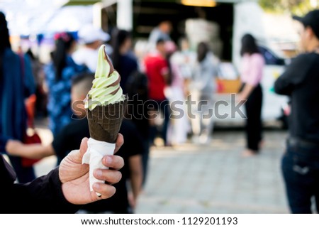 Melon and chocolate ice cream in charcoal cone at outdoor.