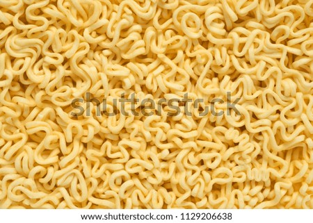 Raw uncooked instant noodles background or texture