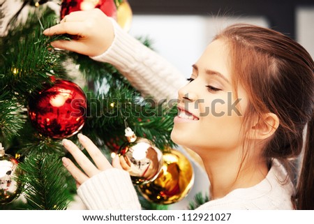 bright picture of woman decorating christmas tree
