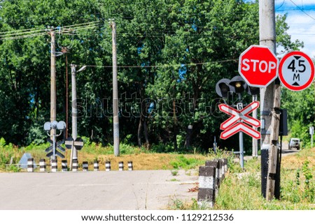 Railroad crossing over country road in forest