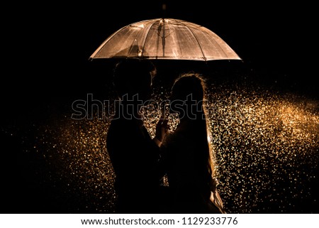 Silhouette couple prewedding under umbrella and dust water background