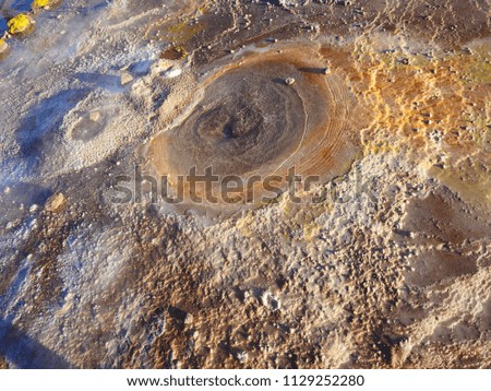 Orange, yellow, brown close-up, texture, background picture of a geyser from El Tatio, a geyser field located within the Andes Mountains of northern Chile, South America, at very high altitude. 