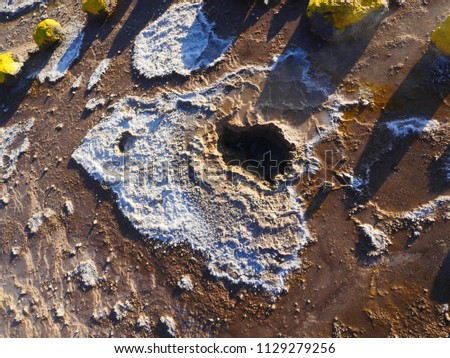 Close up picture of a geyser hole that ejects hot water, steam and minerals in El Tatio, a geyser field located in the Andes Mountains of northern Chile near San Pedro de Atacama in South America.