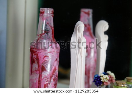 altar with statue of Santa Catolica Nossa Senhora Aparecida and art in bottle with the image of the Santa of Brazil
