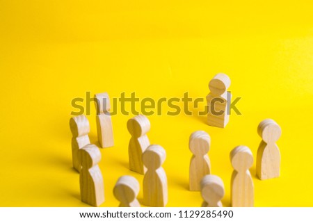 A group of people stands and looks at the leader. Business concept of leadership, management. Corporate hierarchy, head of department. Follow the leader. Head of the company. Opposition.
