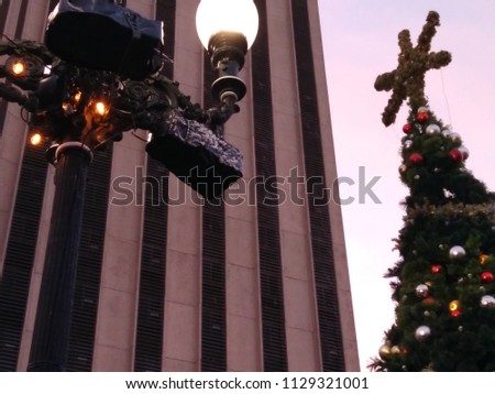 Christmas Tree at the Spanish Plaza, square, in New Orleans, Luisiana, United States. The tree was located next to a street lamp and decorated with a star in its top with colorful ornaments balls. 