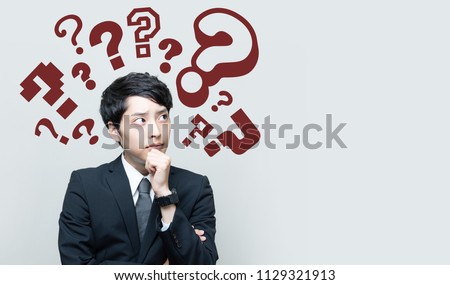young man with question marks.