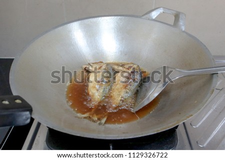 Saltwater fish fried in a pan. Old vegetable oil. Thai  food. mackerels in the pan. Picture of cooking fried mackerel.
