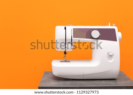 Modern sewing machine on table against color background