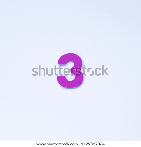 Wooden number 3 with purple color on white background.