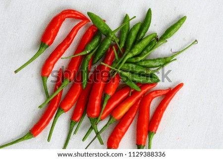 Red and green fresh chilli pepper on the white background