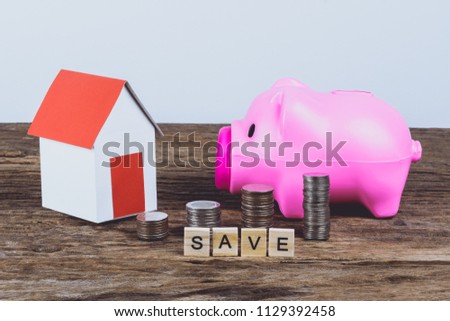 Paper house model, Piggybank and stack of coins with Words SAVE made block wooden letters. Wood abc. Time to Saving Concept