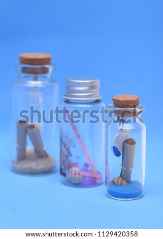 mini glass bottles isolated on white and blue background. Some images may have over exposure effect
