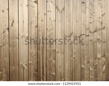 
Tightly fitted vertical boards with a well-visible wooden texture. Background structure.					