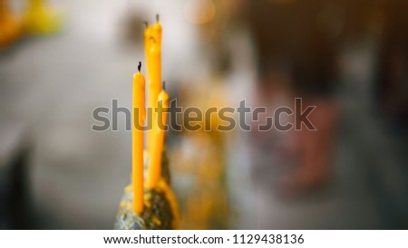 yellow candle in the row