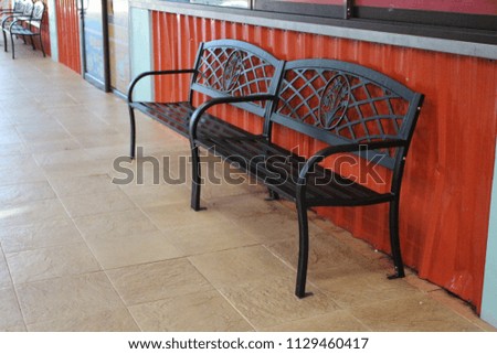 Black benches in the cafeteria.