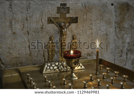 a candle in the church before the crucifixion