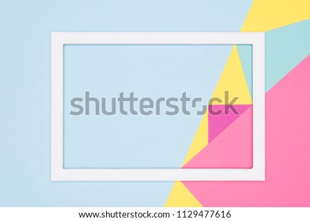 Abstract geometry flat lay pastel blue, pink and yellow paper texture minimalism background. Minimal geometric shapes and lines template with empty picture frame mock up.