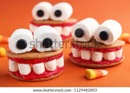 Halloween cookies mouth with marshmallows on orange background