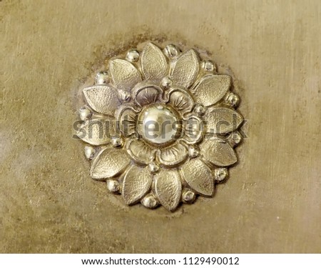Golden decorative element in the form of a flower