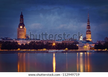 Vintage photo of night Riga cityscape. Latvia