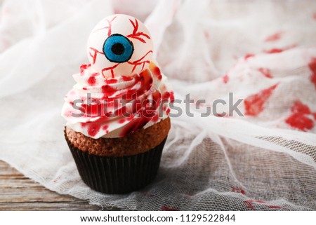 Halloween cupcake on grey wooden table