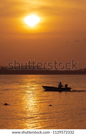 Evening seascape, water and boat at sunset