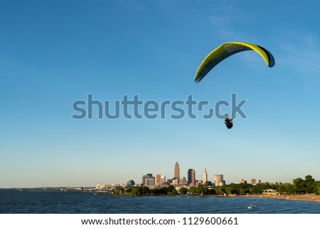 Paraglider over Lake Erie with Cleveland skyline in background