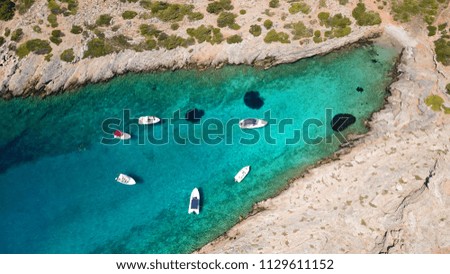 Aerial photo of tropical rocky seascape with beutiful turquoise clear sea and boats docked