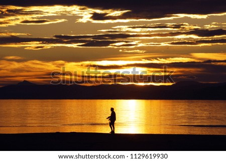 Man watching sunset at Delta del Ebro natural park, Catalonia, Spain