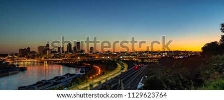 Downtown St. Paul Minnesota sunset cityscape landscape skyline. Light trails, state capital, skyscrapers, mississippi river, railroad Royalty-Free Stock Photo #1129623764