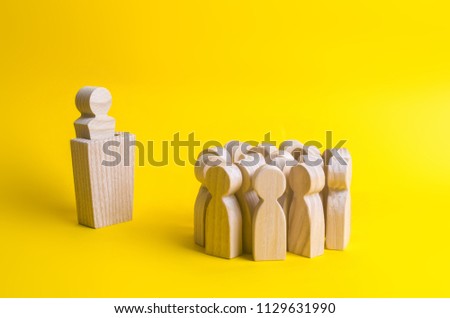 The leader from the rostrum speaks a speech addressing a crowd of people. Business concept of leader and leadership qualities, crowd management, political debate and elections. Business management. Royalty-Free Stock Photo #1129631990