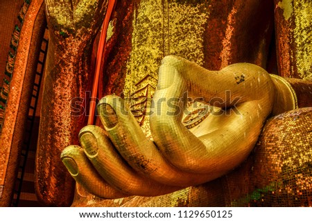 Golden hand of budha in the posture of giving blessings at Wat Tham Sua, Kanchanaburi, Thailand