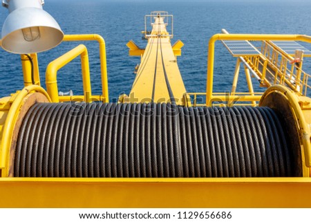 Wire rope sling or cable sling on crane reel drum  or winch roll of crane the lifting machine in heavy industrial Royalty-Free Stock Photo #1129656686