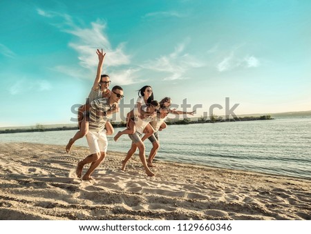Happiness Friends fun on the beach under sunset sunlight in summer suny day. Royalty-Free Stock Photo #1129660346