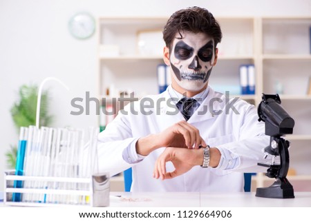 Scary monster doctor working in lab Royalty-Free Stock Photo #1129664906