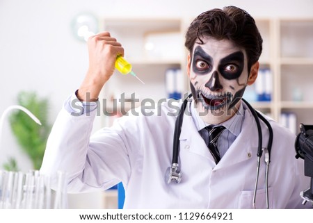 Scary monster doctor working in lab Royalty-Free Stock Photo #1129664921