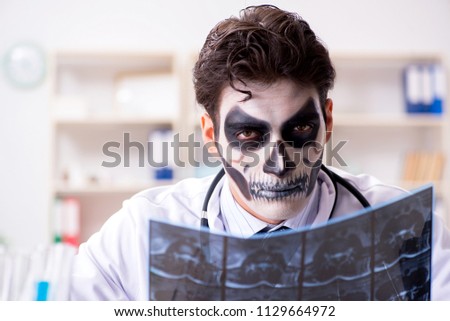 Scary monster doctor working in lab Royalty-Free Stock Photo #1129664972