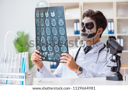 Scary monster doctor working in lab Royalty-Free Stock Photo #1129664981